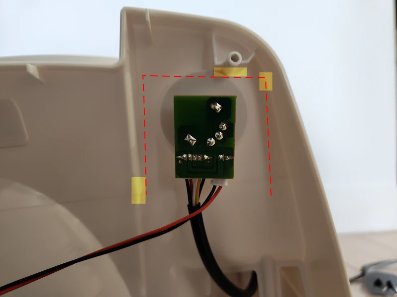 The new PCB mounted inside the fan. Dashed red lines and yellow highlighted rectangles indicate protrusions in the housing which constrained possible board dimensions.